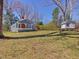 Charming cottage-style home with blue siding, white trim, covered porch and spacious yard at 774 Cornelius St, Hillsborough, NC 27278