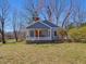 Quaint cottage with blue siding, white trim, and a covered porch for outdoor seating at 774 Cornelius St, Hillsborough, NC 27278
