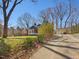 View of a blue cottage-style home, detached garage, and a long driveway at 774 Cornelius St, Hillsborough, NC 27278