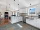 Bright kitchen with white cabinetry, granite countertops, stainless steel appliances, and dark slate flooring at 774 Cornelius St, Hillsborough, NC 27278