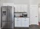 Kitchen area with stainless steel refrigerator and white cabinets and granite countertop space at 774 Cornelius St, Hillsborough, NC 27278