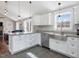 Modern kitchen with stainless appliances, granite counters, and a view into the living space at 774 Cornelius St, Hillsborough, NC 27278