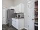 Kitchen area with stainless steel refrigerator, pantry and white cabinets with granite countertop at 774 Cornelius St, Hillsborough, NC 27278