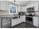 Bright kitchen features white cabinets, stainless steel appliances, granite countertops and pendant lighting at 774 Cornelius St, Hillsborough, NC 27278