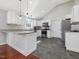 Modern kitchen with stainless steel appliances, white cabinets, and granite countertops at 774 Cornelius St, Hillsborough, NC 27278