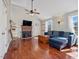 Cozy living room boasts a fireplace, hardwood floors, and a comfortable blue couch at 774 Cornelius St, Hillsborough, NC 27278