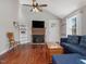 Bright living room featuring high ceilings, a brick fireplace, and gleaming hardwood floors at 774 Cornelius St, Hillsborough, NC 27278