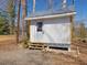 A charming outbuilding featuring a modern white door with a metal roof at 774 Cornelius St, Hillsborough, NC 27278