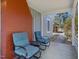 Cozy covered porch featuring seating, a brick accent wall, and a view of the property at 774 Cornelius St, Hillsborough, NC 27278