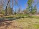 Green yard and trees offering a serene setting with potential for landscaping at 774 Cornelius St, Hillsborough, NC 27278