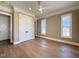 Bedroom featuring hardwood floors, double-door closet, and bright natural light at 7808 Ailesbury Rd, Wake Forest, NC 27587