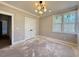 Spacious bedroom with hardwood floors, a modern ceiling light, and a double-door closet at 7808 Ailesbury Rd, Wake Forest, NC 27587