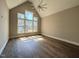 Bright bedroom with vaulted ceilings, hardwood floors, large windows, and a ceiling fan at 7808 Ailesbury Rd, Wake Forest, NC 27587