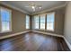 Bedroom filled with natural light features hardwood floors and large windows at 7808 Ailesbury Rd, Wake Forest, NC 27587