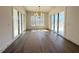 Bright dining room featuring hardwood floors, large windows, and sliding glass doors at 7808 Ailesbury Rd, Wake Forest, NC 27587