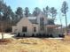 Elegant two-story home with large windows, covered porch, attached garage, and modern architectural details at 7808 Ailesbury Rd, Wake Forest, NC 27587