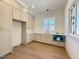 Well-lit kitchen with custom cabinets, quartz countertops, stainless steel fixtures, and hardwood floors at 7808 Ailesbury Rd, Wake Forest, NC 27587