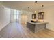 Open-concept area featuring hardwood floors and an island with pendant lighting at 7808 Ailesbury Rd, Wake Forest, NC 27587