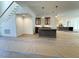 Open-concept living area with hardwood floors, staircase, kitchen, and modern pendant lighting at 7808 Ailesbury Rd, Wake Forest, NC 27587