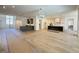 Open-concept living space with hardwood floors, a staircase, and eat-in kitchen with island at 7808 Ailesbury Rd, Wake Forest, NC 27587