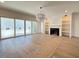 Elegant living room with hardwood floors, fireplace, built-in shelving, and sliding glass doors at 7808 Ailesbury Rd, Wake Forest, NC 27587