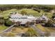 Aerial view of clubhouse with well-manicured grounds and golf course in the background at 8000 N Bridgewater Ct, Raleigh, NC 27615