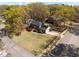 Aerial view of two-story home featuring a landscaped yard, mature trees, and a brick exterior at 8000 N Bridgewater Ct, Raleigh, NC 27615