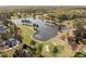 Aerial view of a pristine lake surrounded by a golf course and luxury homes at 8000 N Bridgewater Ct, Raleigh, NC 27615