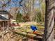 Grassy backyard with a tree swing and spacious wooden deck at 8000 N Bridgewater Ct, Raleigh, NC 27615