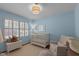 Light-filled Bedroom with window and comfortable seating area at 8000 N Bridgewater Ct, Raleigh, NC 27615