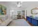 Charming Bedroom featuring a blue dresser, white rocking chair, plush rug, and playful decor at 8000 N Bridgewater Ct, Raleigh, NC 27615