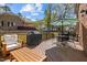Spacious wooden deck featuring multiple seating areas and barbecue grill at 8000 N Bridgewater Ct, Raleigh, NC 27615