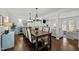 Spacious dining room featuring a large wood table, chandelier lighting, and elegant decor for gatherings at 8000 N Bridgewater Ct, Raleigh, NC 27615