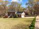 Spacious property with a brick home, expansive lawn, and mature trees, ideal for outdoor enjoyment at 8000 N Bridgewater Ct, Raleigh, NC 27615