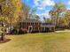 Beautiful two-story brick home with a large front lawn and mature trees, offering classic charm at 8000 N Bridgewater Ct, Raleigh, NC 27615
