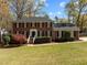Classic two-story brick home with black shutters and a well-manicured lawn, exuding curb appeal at 8000 N Bridgewater Ct, Raleigh, NC 27615