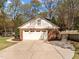 Detached two-car garage featuring brick facade, painted siding, and concrete driveway at 8000 N Bridgewater Ct, Raleigh, NC 27615