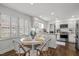 Eat-in kitchen featuring stainless appliances, stone countertops, and white cabinetry at 8000 N Bridgewater Ct, Raleigh, NC 27615