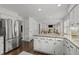 Spacious kitchen with granite countertops, stainless steel appliances, and seamless transition to the living areas at 8000 N Bridgewater Ct, Raleigh, NC 27615
