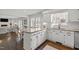 Open kitchen with white cabinets, granite countertops, and view into the dining and living areas at 8000 N Bridgewater Ct, Raleigh, NC 27615
