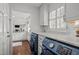 Convenient laundry room with front load washer/dryer, granite countertops, and natural light at 8000 N Bridgewater Ct, Raleigh, NC 27615