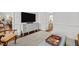 Open living room with a decorative cabinet and view to the eat-in kitchen at 8000 N Bridgewater Ct, Raleigh, NC 27615