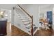 Elegant staircase with white railings and dark wood steps, blending classic design with modern style at 8000 N Bridgewater Ct, Raleigh, NC 27615