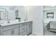 Bathroom features double vanity, modern fixtures, and a clean design with a view into the main bedroom at 1007 Shovelhead Dr # 4, Durham, NC 27703