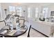 Sunlit dining area featuring a round table set for a meal, with views into the cozy living room at 1007 Shovelhead Dr # 4, Durham, NC 27703