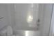A bathroom with an all-white shower/tub with shelves and a toilet at 912 Martin Luther King Jr Dr, Smithfield, NC 27577
