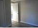 A bedroom with gray walls and light hardwood-look floors, featuring an open white paneled door at 912 Martin Luther King Jr Dr, Smithfield, NC 27577