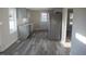 Modern kitchen with gray cabinets, stainless steel appliances, and newly installed vinyl flooring at 912 Martin Luther King Jr Dr, Smithfield, NC 27577