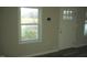 Bright living room featuring a new vinyl floor, a window, and a freshly painted white door at 912 Martin Luther King Jr Dr, Smithfield, NC 27577