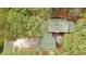 A bird's eye view reveals this home's layout with a spacious driveway and outdoor deck, surrounded by verdant foliage at 917 Queensferry Rd, Cary, NC 27511